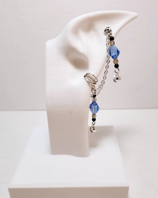 Beaded earring on a white ear stand with a plain background