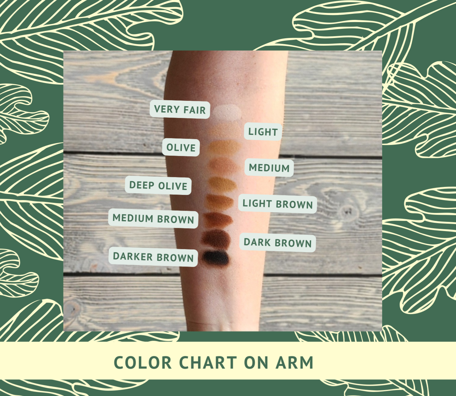 Color chart on arm with labeled shades against a wooden background