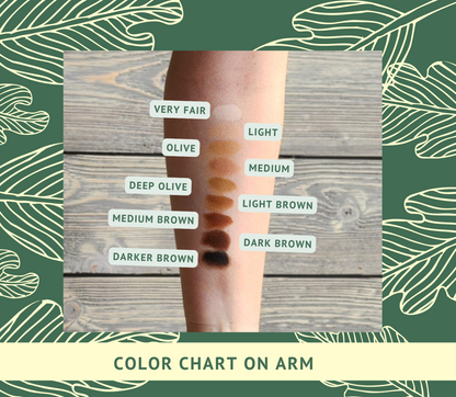 Color chart on arm with labeled shades against a wooden background